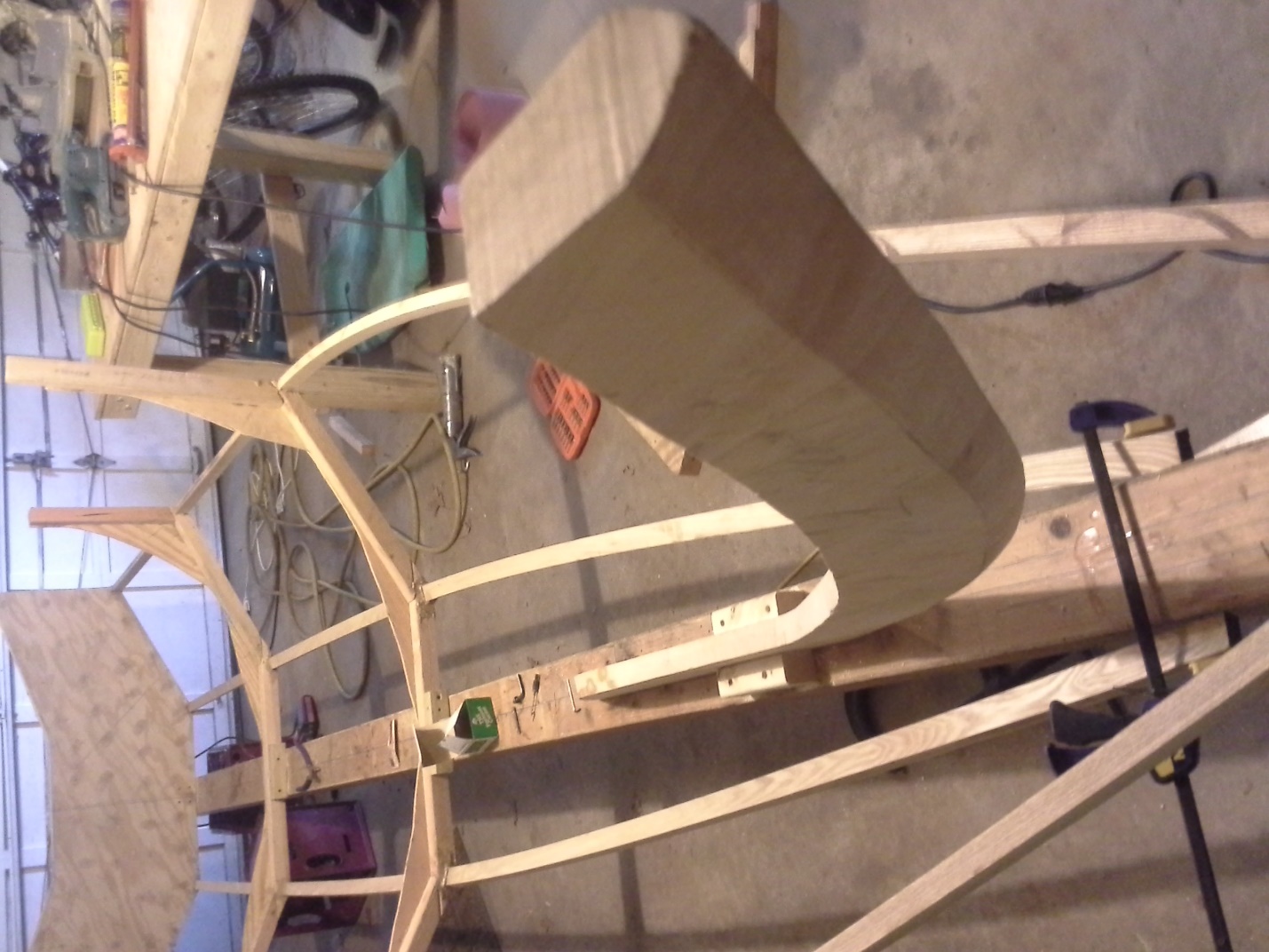Bending ash chines into shape onto the frames and transom